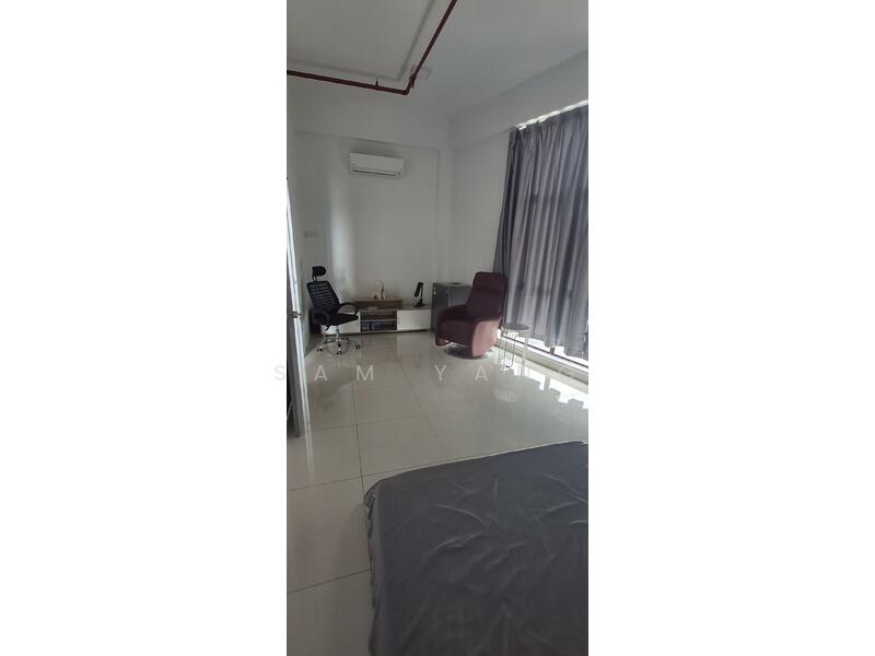 Large bedroom with fridge and TV table.