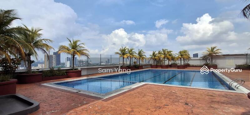 Swimming pool surrounded by palm trees.